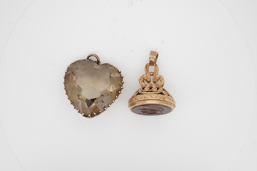 A modern 9ct gold and carnelian set fob seal, the matrix carved with the bust of a soldier to dexter, 30mm, together with a yellow metal and citrine set heart shaped pendant. Condition - fair to good